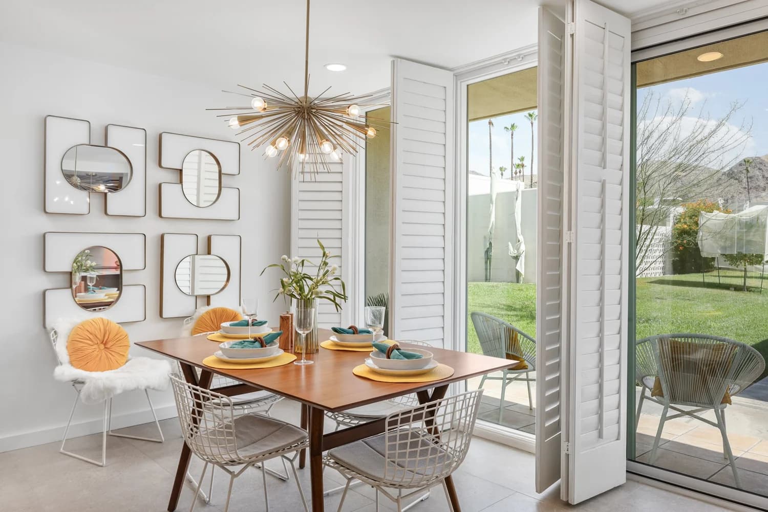 Staged dining room opening onto a garden